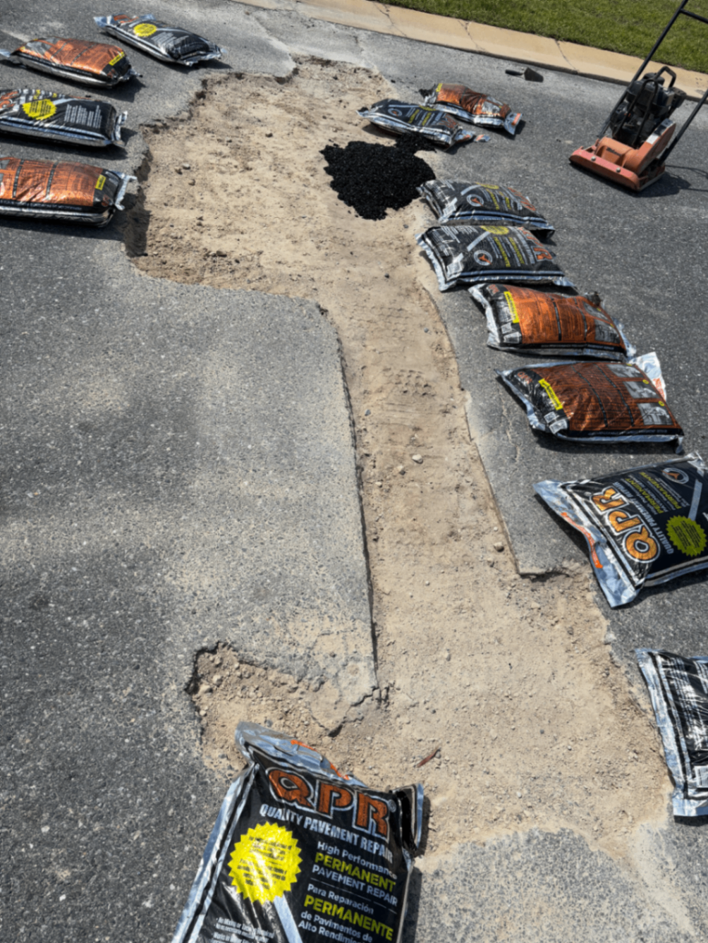 Road repair area before pavement patch work at Arrazo on Madison home development